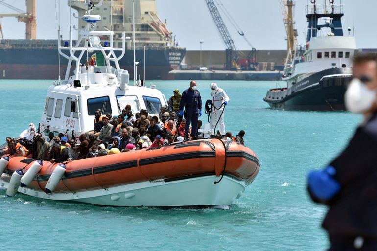 An Italian Coast Guard ship carrying migrants arrives at Pozzallo''s harbor near Ragusa,