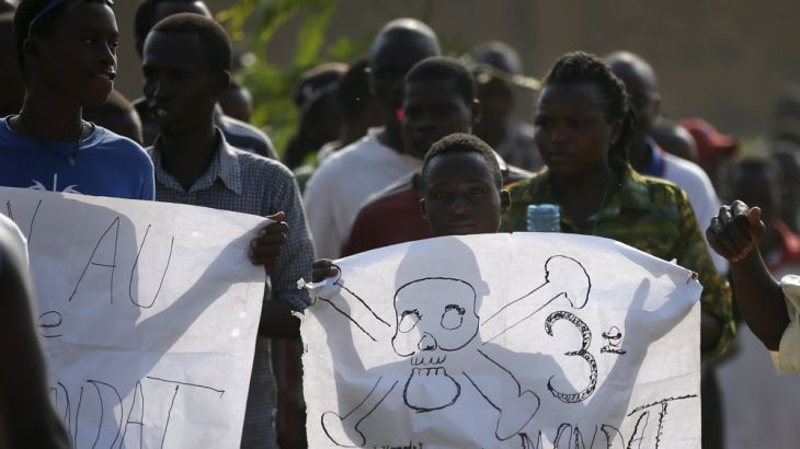 A protester holds a banner during a protest against President Pierre Nkurunziza''s decision to run for a third term in Bujumbura