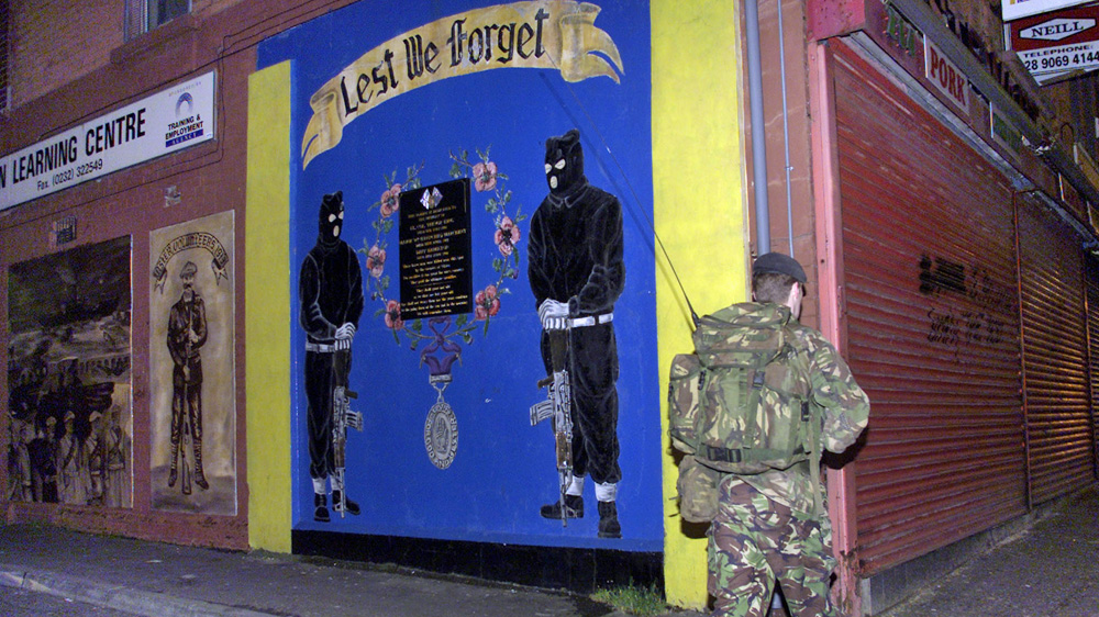 A British soldier foot-patrols Shankill Road, west Belfast, in 2001 [Reuters]