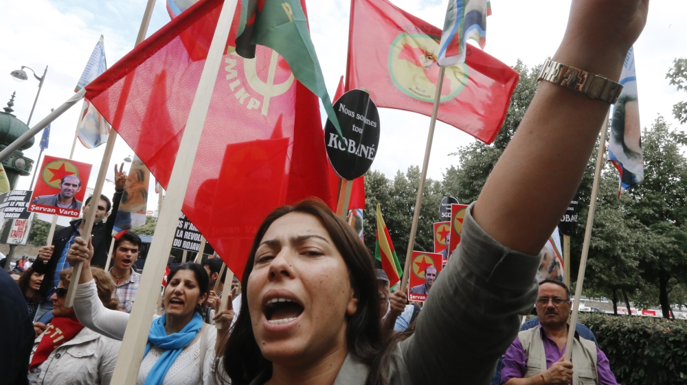 Kurdish demonstrators protest near the Turkish embassy in Paris as claims emerge that Turkey is targeting Kurds in Syria [AP]