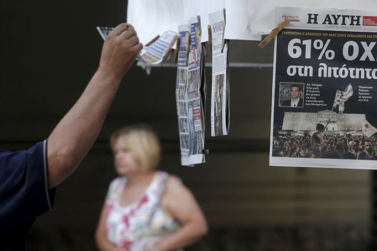 A man looks at newspapers showing the results of Sunday''s referendum in central Athens, Greece [REUTERS]