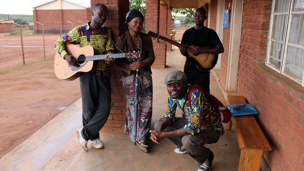 Tresor and the refugee musicians at Dzaleka Refugee Camp [Al Jazeera]