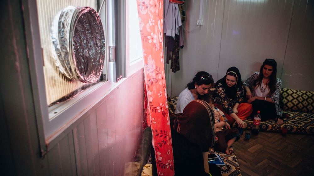 The women make a house call to a Yazidi relative [Andrea DiCenzo/Al Jazeera]