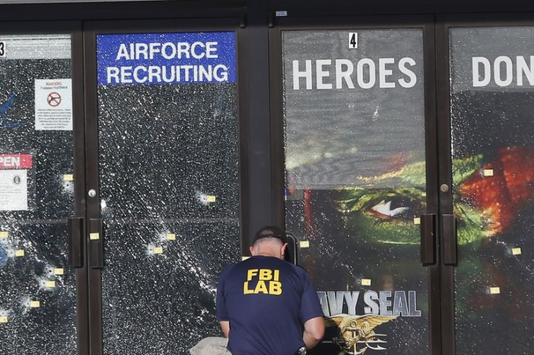 FILE - In this July 17, 2015 file photo, an FBI investigator investigates the scene of a shooting outside a military recruiting