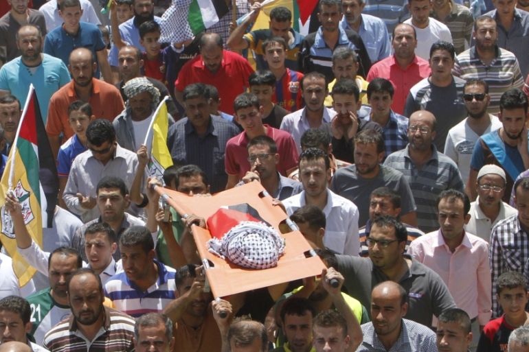 Mourners carry the body of 18-month-old Palestinian baby Ali Dawabsheh, who was killed after his family's house was set on fire in a suspected attack by Jewish extremists in Duma village near Nablus