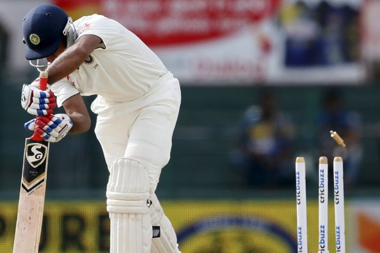 India''s Pujara is bowled out by Sri Lanka''s Prasad during the third day of their third and final test cricket match in Colombo