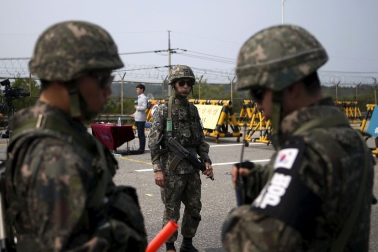 South Korean soldiers stand guard at a checkpoint on the Grand Unification Bridge which leads to the truce village Panmunjom, just south of the demilitarized zone separating the two Koreas, in Paju