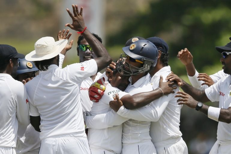 Sri Lanka''s Herath celebrates with his teammates after taking the wicket of India''s Rahane on the fourth day of their first test cricket match in Galle