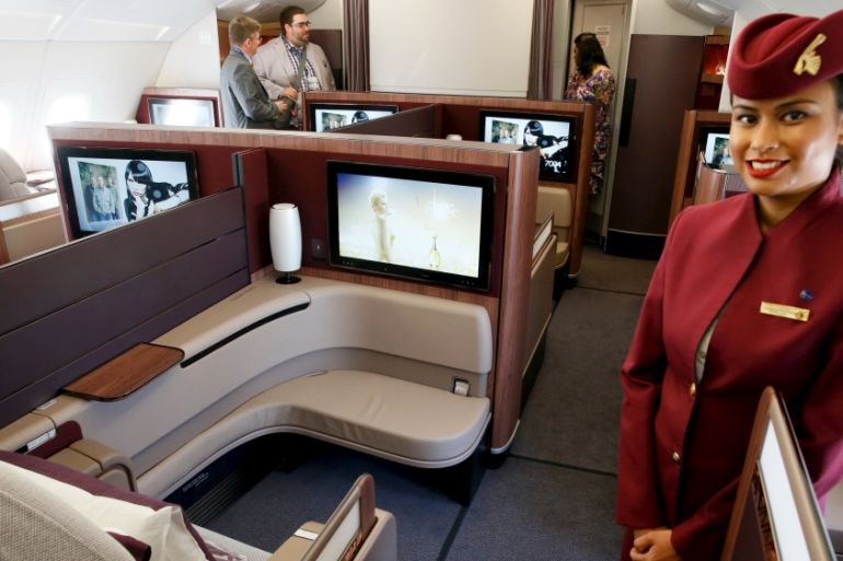 Qatar Airways crew member presents the first class seats of an Airbus A380 aircraft during the 51st Paris Air Show at Le Bourget airport near Paris