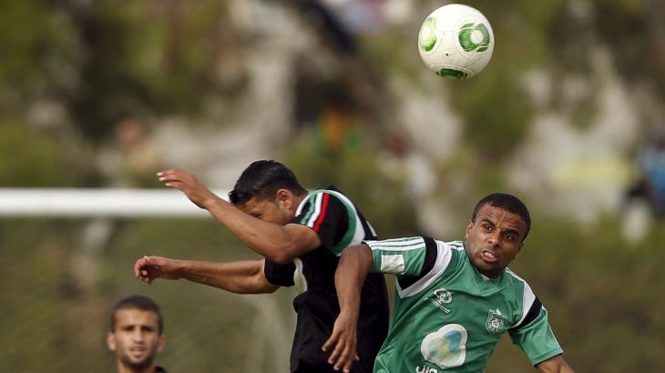 Ala''a Ateya of Ittihad Shejaiya fights for the ball with a player from Rafah during their Gaza Strip Cup final soccer match in Gaza City