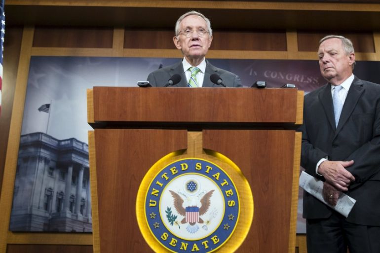Senate Minority Leader Harry Reid (D-NV) and Senator Dick Durbin (D-IL) speak after a vote failed to advance debate on a nuclear agreement with Iran, in Washington
