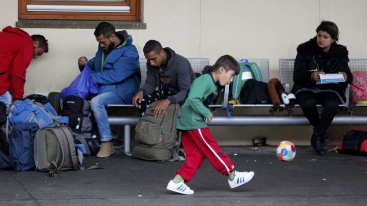 A child plays with a ball as migrants wait for trains at Wien Westbahnhof in Vienna
