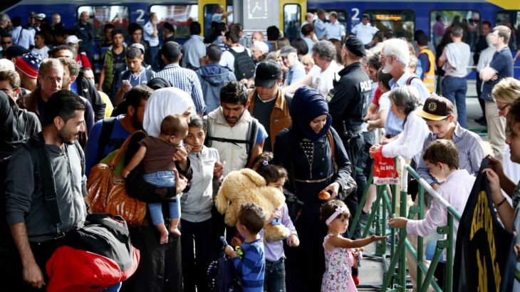 Migrants walk on the platform in Munich