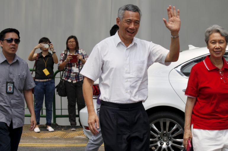 Singapore''s Prime Minister and Secretary-General of the People''s Action Party Lee Hsien Loong and his wife Ho Ching arrive to cast their votes at a polling center in Singapore