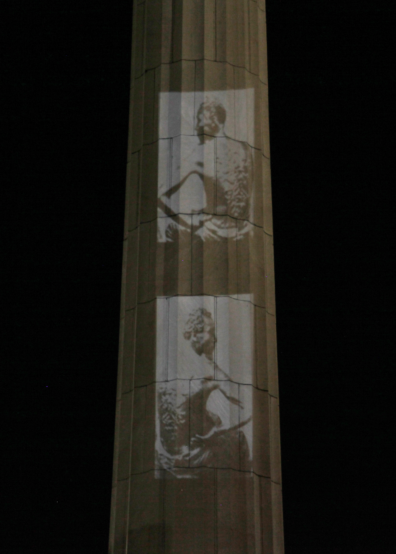 The Take 'Em Down NOLA group projected images of the scarred backs of slaves onto a monument to Confederate General Robert E Lee [Roopa Gogineni] [Daylife]