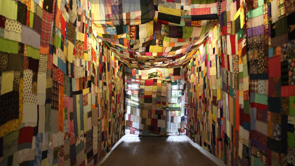 The artist created the colourful patchwork art in honour of his mother [Mark Fenn/Al Jazeera]