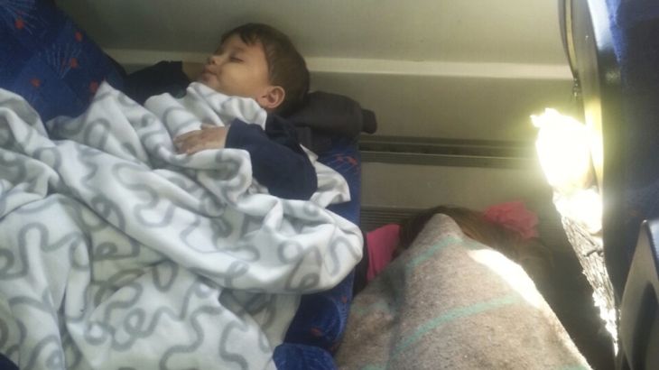 Refugee child sleeps in carriage of a train at Bicske railway station