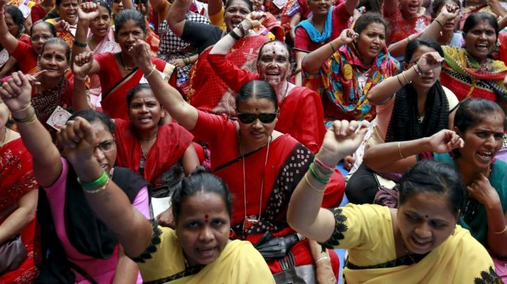 Workers from various trade unions shout slogans during an anti-government protest rally, organised as part of a nationwide strike, in Mumbai