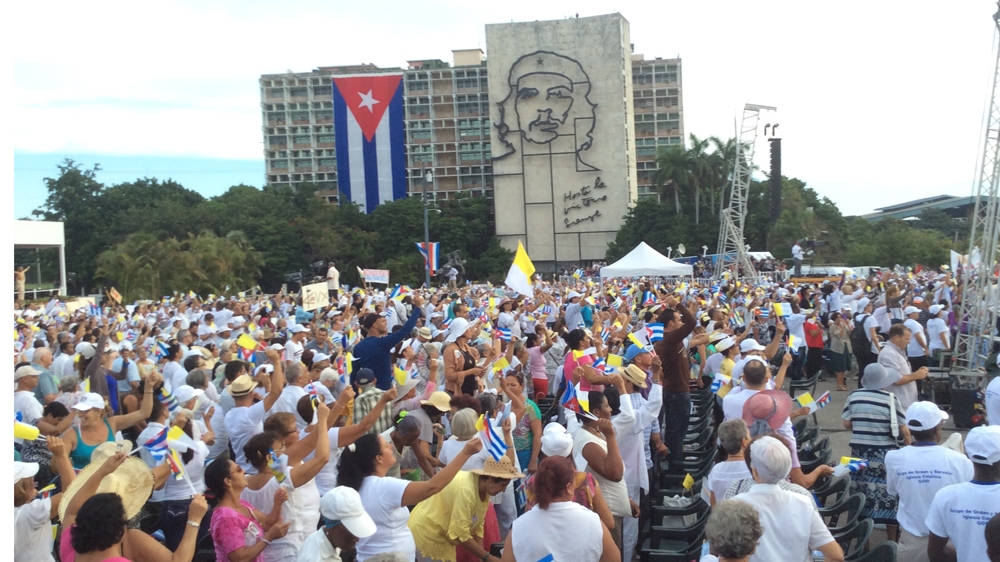 Hundreds of thousands attended the mass under the gaze of revolutionary icon Che Guevara at Havana's Plaza of the Revolution [Lucia Newman / Al Jazeera]