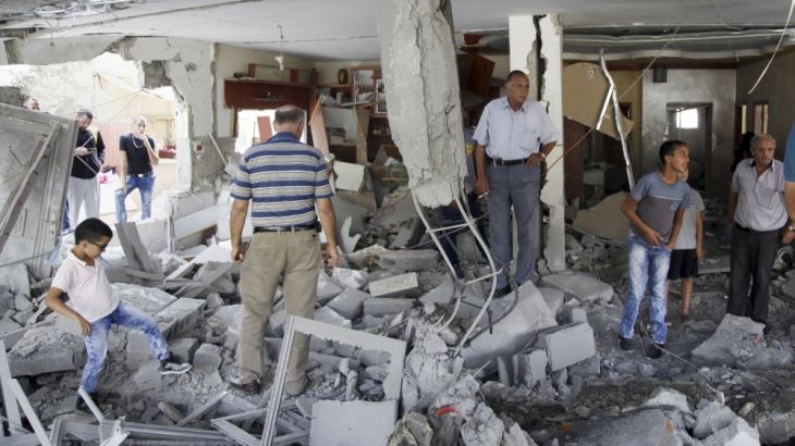 Palestinians inspect the home of the Abu Jaber family