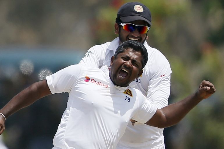 Sri Lanka''s Herath celebrates with his teammate Karunaratne after taking the wicket of India''s Rahane on the fourth day of their first test cricket match in Galle