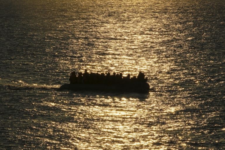 A raft with migrants and refugees approach the Greek island of Lesbos