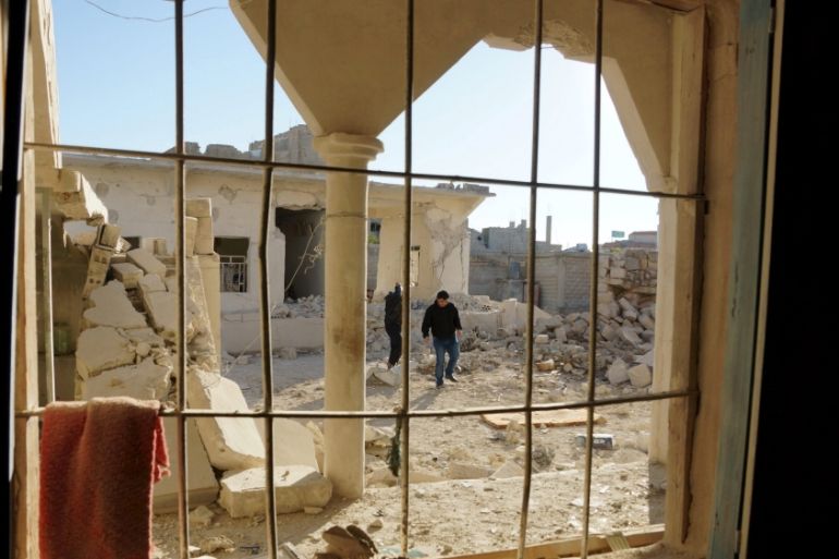 Men inspect a site hit by what activists said were airstrikes by forces loyal to Syria''s President Bashar al-Assad in Sheikh Meskeen near Deraa