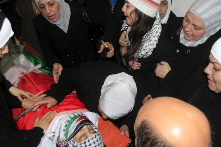 Relatives of Palestinian Maher Aljabi, whom medics said was shot and killed by Israeli troops on Saturday, mourn around his body during his funeral in the West Bank city of Nablus