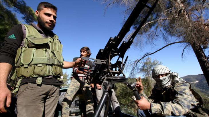 Syrian Turkmen fighters are seen with an anti-aircraft artillery weapon near the northern Syrian village of Yamadi, near the Turkish-Syrian border, Syria
