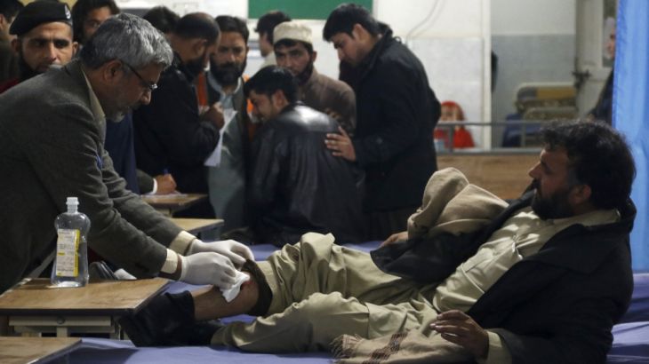 A man, who sustained injuries in a suicide attack at a government office, receives first aid at the Lady Reading Hospital in Peshawar