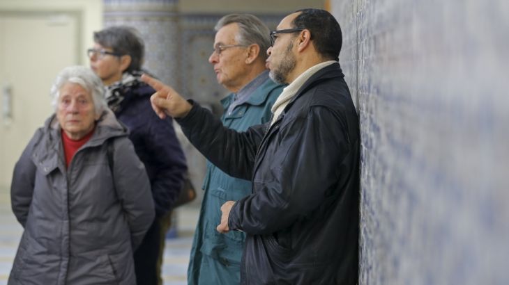 People listen to the explanations of guide Loubardi as they visit the Strasbourg Grand Mosque during an open day weekend for mosques in France