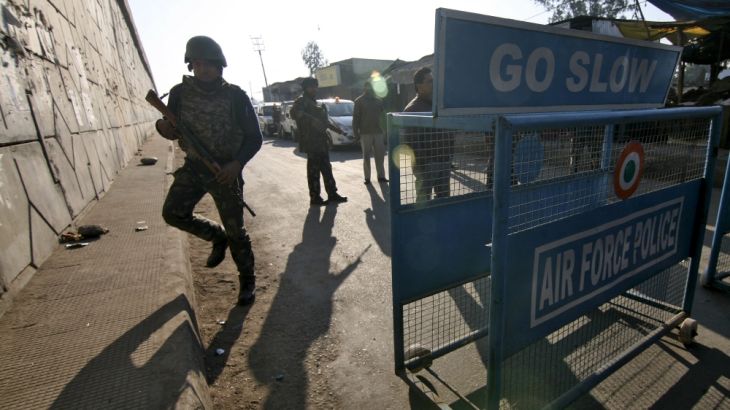 Indian security personnel stand guard next to a barricade outside IAF base at Pathankot in Punjab