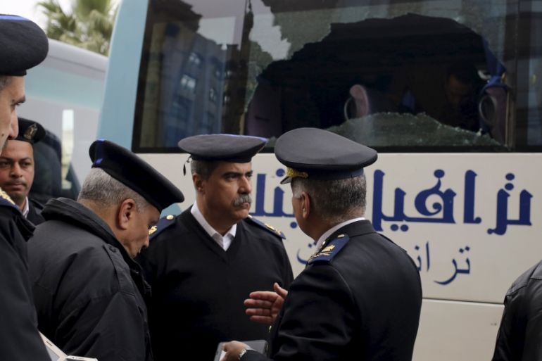 Police are seen at the scene where gunmen attacked a tourist bus in front of a hotel in Giza