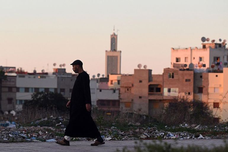A Moroccan man walks in a street in the port city of Al-Muhammadiyah [AFP]