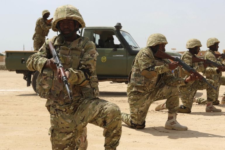 Members of the Somali military perform a defensive drill after attending a commando training exercise at the United Arab Emirates military training camp in Mogadishu