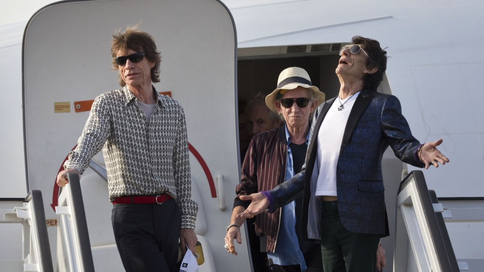 Members of The Rolling Stones, from right, Ron Wood, Keith Richards and Mick Jagger deplane at Jose Marti international airport [AP]