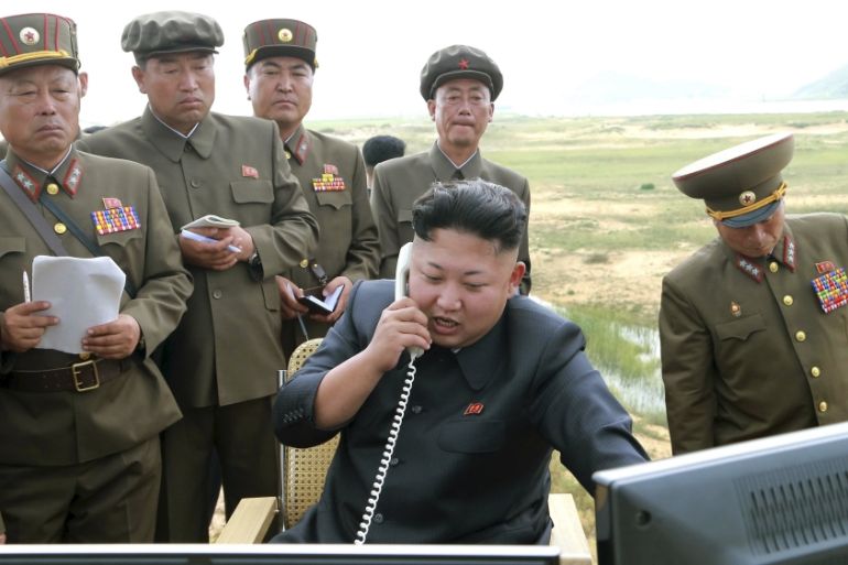 North Korean leader Kim Jung Un guides the test fire of a tactical rocket in this undated file photo