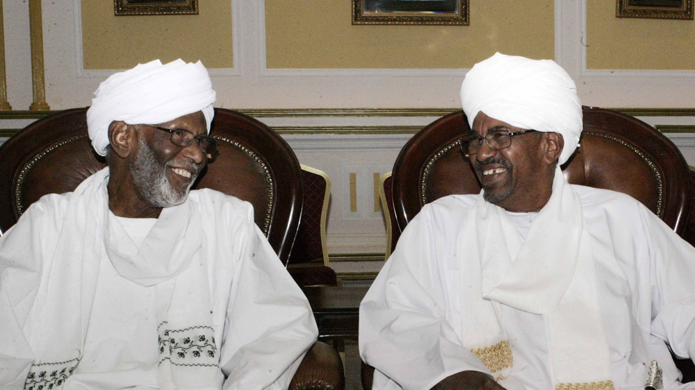 Turabi (left) played a key role in the 1989 coup that brought President Bashir to power [AFP]