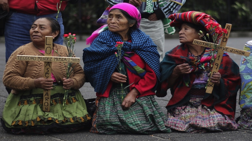 Indigenous women hold crosses during a march to commemorate the National Day of Dignity for the Victims of Armed Internal Conflict, in Guatemala City, on February 25, 2016. The day honours the victims of Guatemala's 36-year civil war, which ended in 1996 [REUTERS/Josue Decavele]