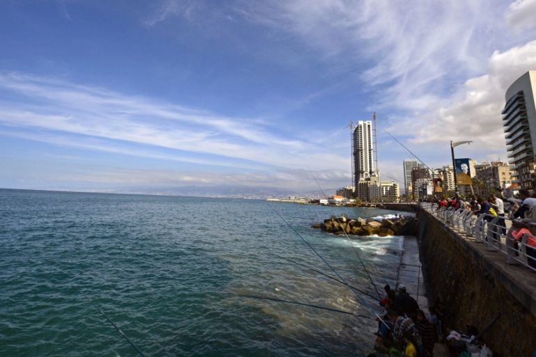 People fish at the coastline of al-Manara during a sunny day in Beirut, Lebanon [EPA}