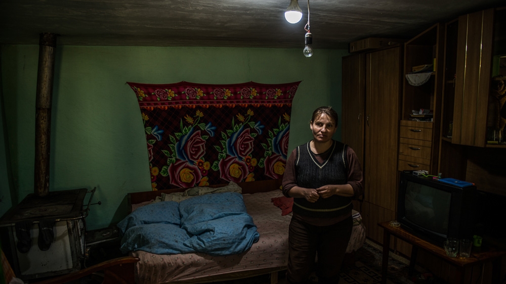 Anishuara Oprea is one of the benefactors of Free Miorita's Light for Romania project. With the help of the solar panel, she can now light up her living room [Felix Gaedtke/Al Jazeera] 