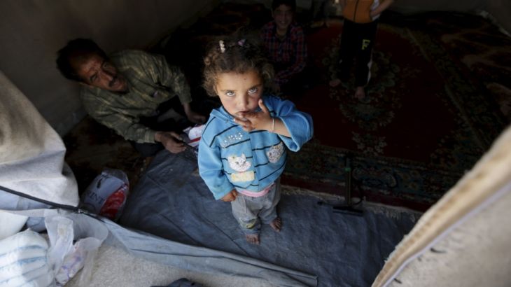 An internally displaced girl stands inside her family''s tent inside a refugee camp in Dana town after fleeing Palmyra, in northern Idlib province