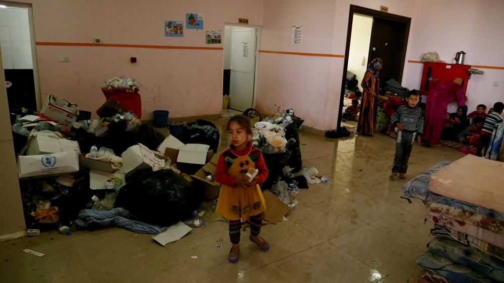 Rubbish collects on the floor of the same building where the displaced families live [Mohammed A Salih/Al Jazeera]