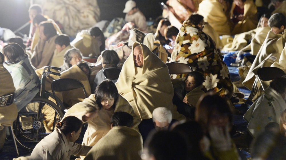 
Japanese media showed residents, some of them wrapped in blankets, huddling in a parking lot [Kyodo News]
