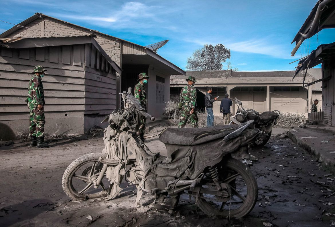 Indonesian soldiers aid in evacuation efforts from a village impacted by the Mount Sinabung eruption at Gamber Village, Simpang Empat, Karo, North Sumatra