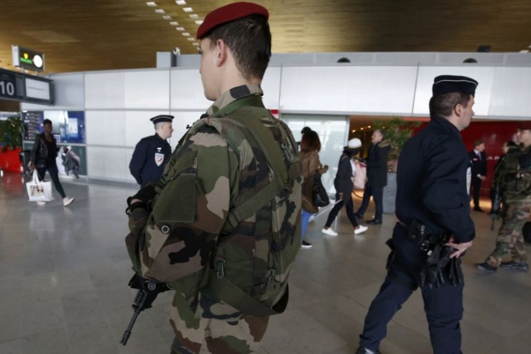 French police and soldiers patrols inside the Charles de Gaulle International Airport in Roissy, near Paris