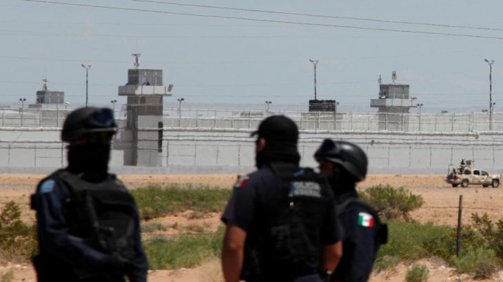 Federal police officers stand guard near a prison in Ciudad Juarez, where Mexican drug boss Joaquin "Chapo" Guzman was moved from his jail, in central Mexico