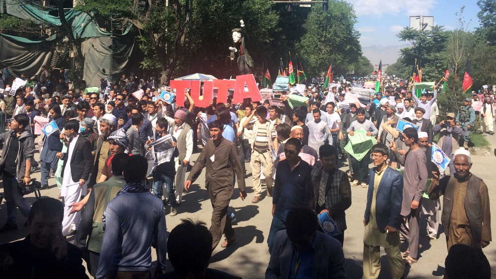 Authorities locked down Kabul as tens of thousands of members of Hazara community protested the proposed route of a power line [Massoud Hossaini/AP]