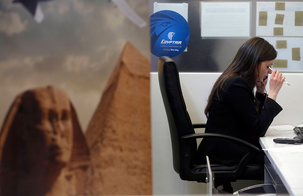 An employee works at the EgyptAir desk at Charles de Gaulle airport, after an EgyptAir flight disappeared from radar during its flight from Paris to Cairo, in Paris, France