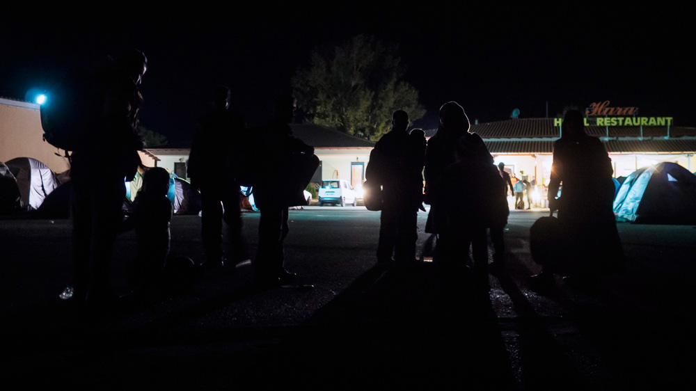Refugees get ready to try and cross the Greek-Macedonian border in the cover of darkness [Lazar Simeonov/Al Jazeera]